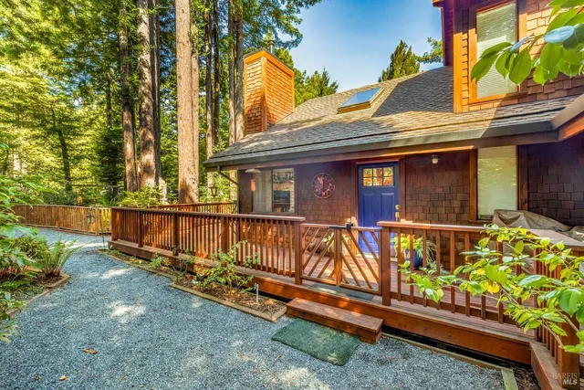a view of a house with wooden fence