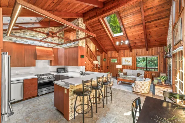 a kitchen with stainless steel appliances granite countertop a refrigerator and a sink