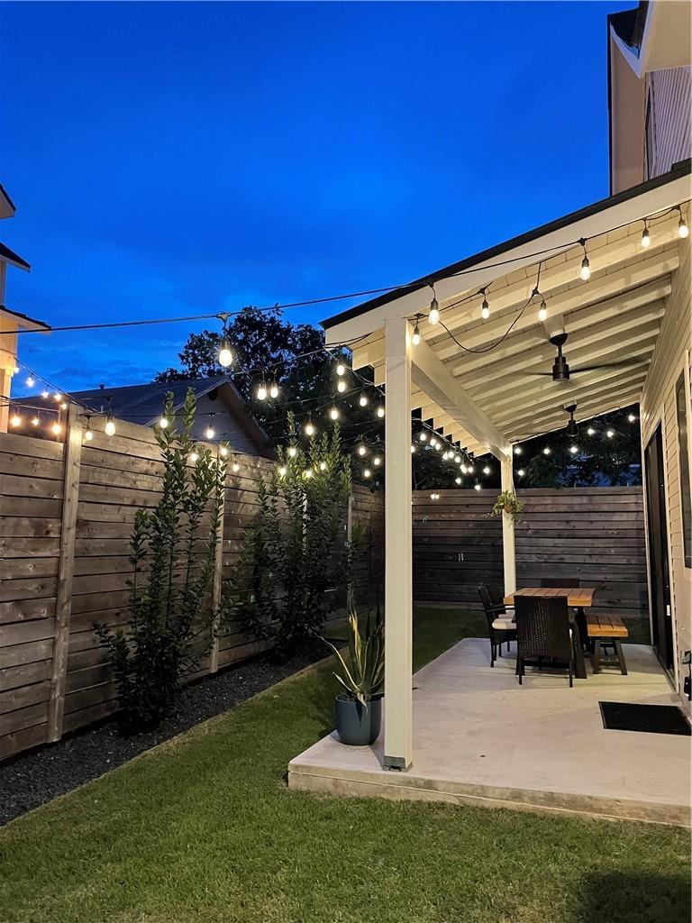 2002 East 9th Street, Unit 2 Austin, TX 78702 - Photo 23 of 32 An inviting outdoor living area awaits under a string-lit covered patio.