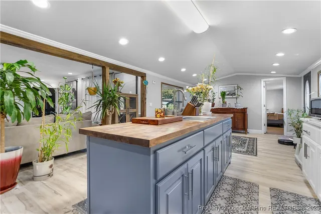 a kitchen with counter top space and living room