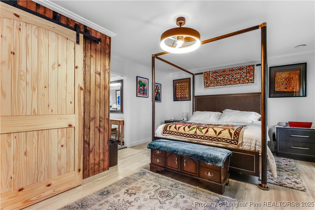 1855 Beaman Woods Road Clinton, NC 28328 - Photo 17 of 50 a view of a bedroom with wooden floor and windows