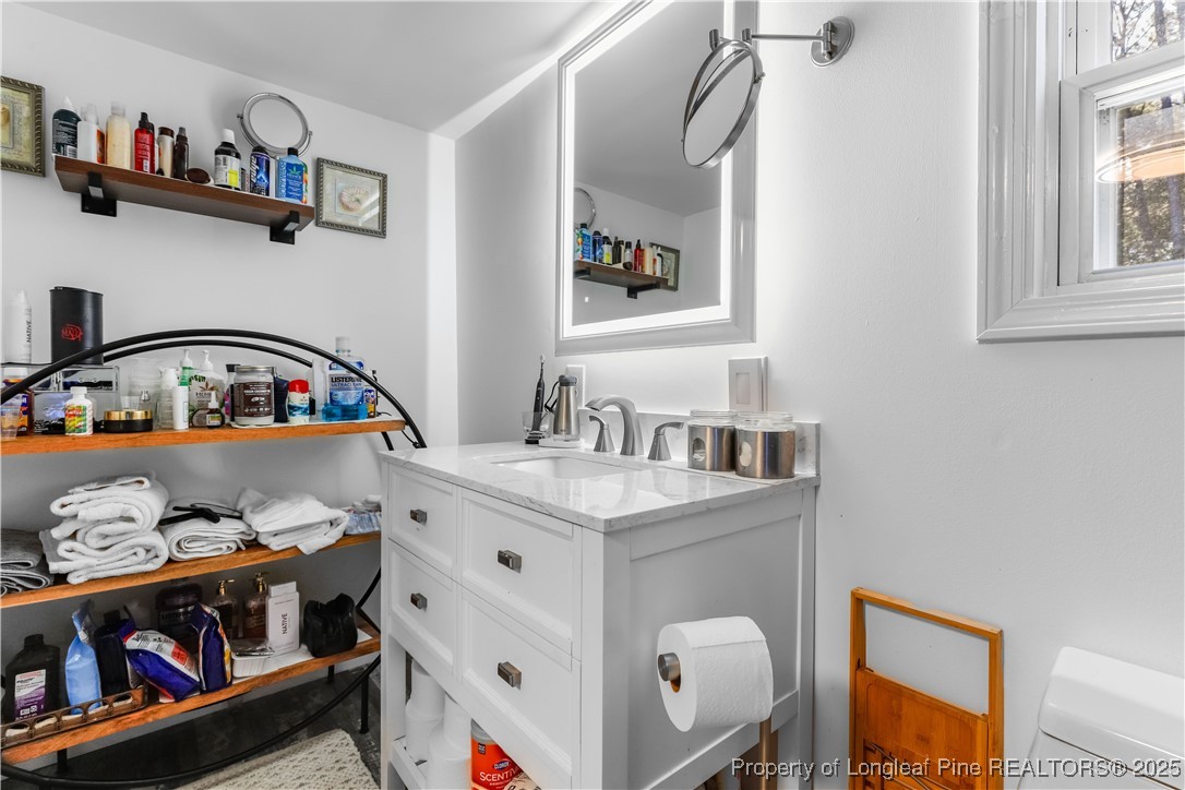 1855 Beaman Woods Road Clinton, NC 28328 - Photo 20 of 50 a bedroom with furniture and a wooden floor