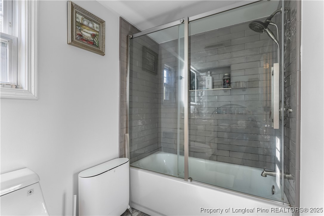 1855 Beaman Woods Road Clinton, NC 28328 - Photo 21 of 50 a bathroom with a bathtub and a shower