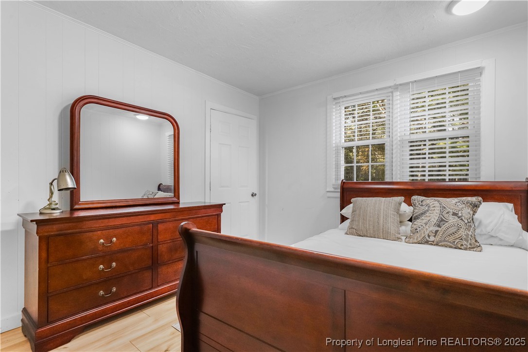 1855 Beaman Woods Road Clinton, NC 28328 - Photo 22 of 50 a bedroom with a bed and a mirror on dresser