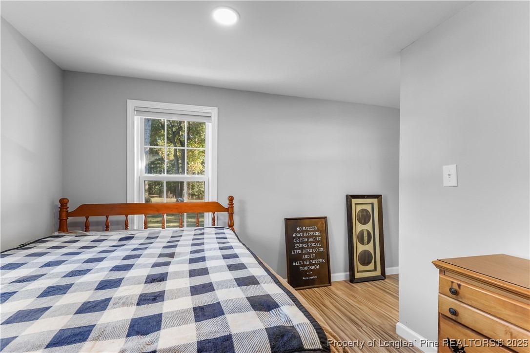 1855 Beaman Woods Road Clinton, NC 28328 - Photo 26 of 50 a bedroom with a bed and a window