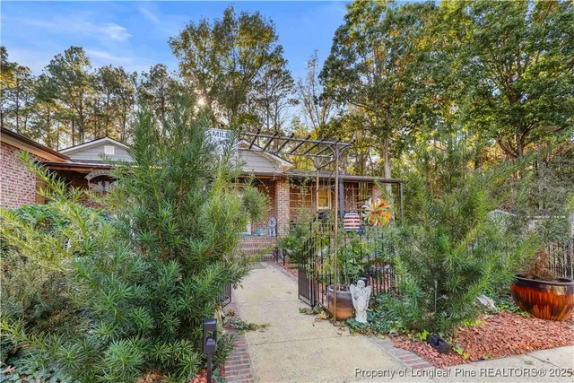 a front view of a house with lots of green space
