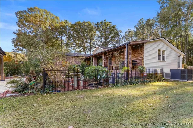 a view of a house with backyard porch and sitting area