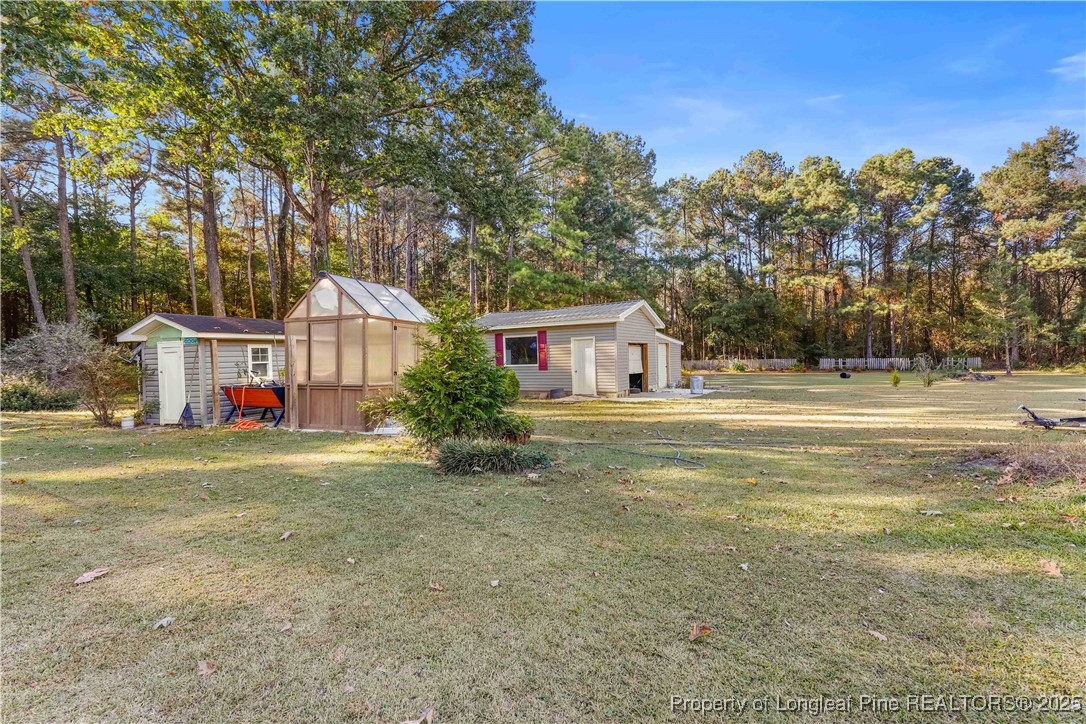 1855 Beaman Woods Road Clinton, NC 28328 - Photo 36 of 50 a front view of house with yard and trees