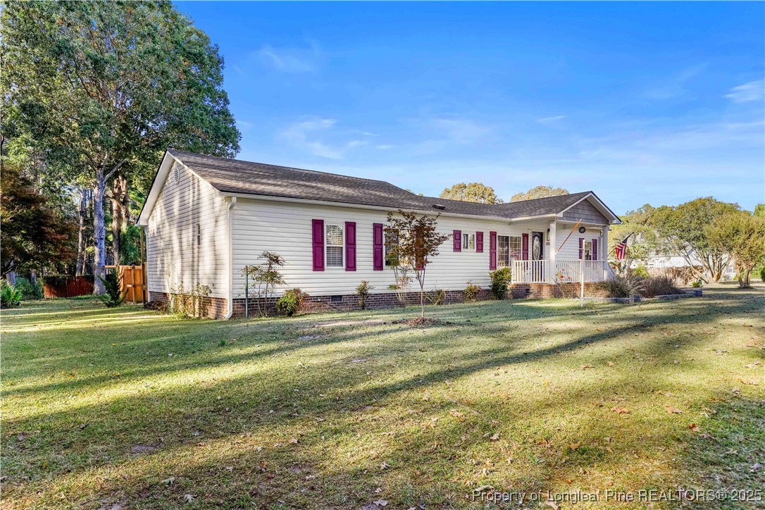 1855 Beaman Woods Road Clinton, NC 28328 - Photo 43 of 50 a front view of a house with a garden