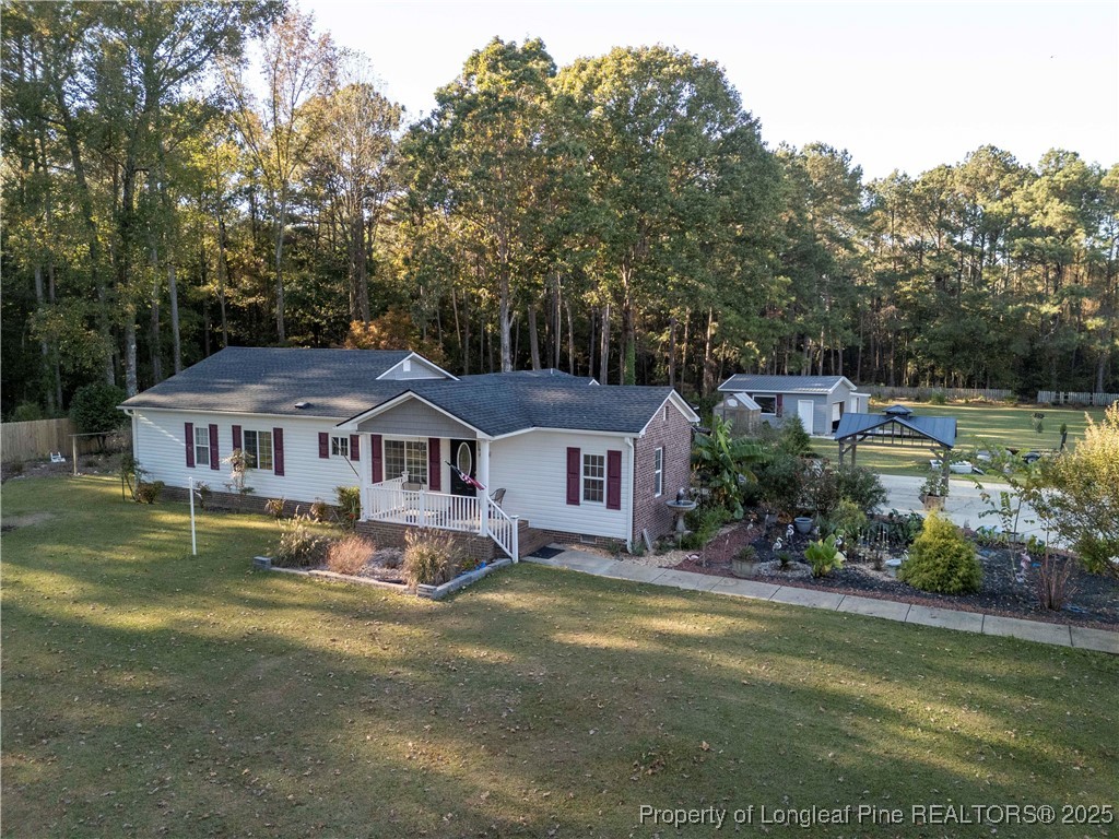1855 Beaman Woods Road Clinton, NC 28328 - Photo 45 of 50 a view of a house with a big yard and large trees