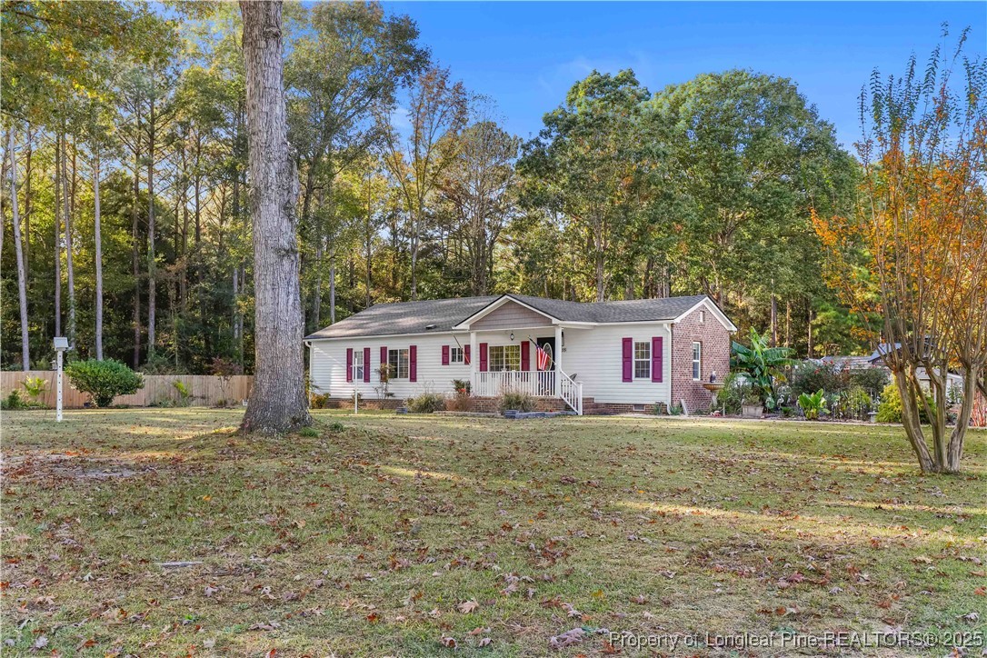 1855 Beaman Woods Road Clinton, NC 28328 - Photo 46 of 50 a white house that has a tree in front of it