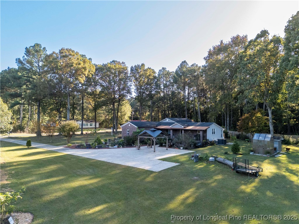 1855 Beaman Woods Road Clinton, NC 28328 - Photo 49 of 50 a view of a house with swimming pool and sitting area