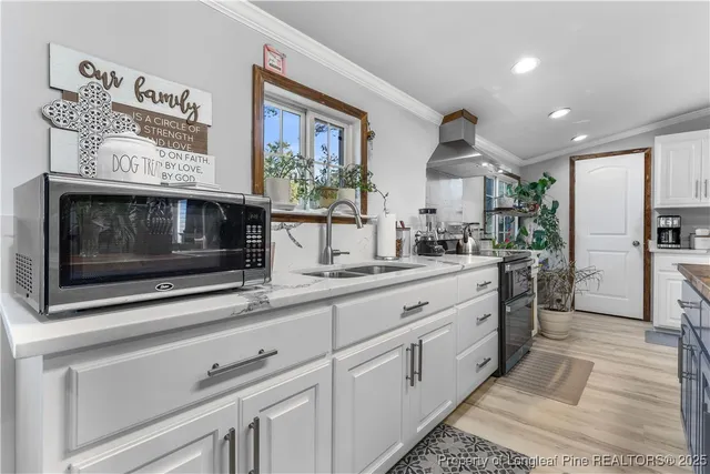 a kitchen with stainless steel appliances kitchen island granite countertop a sink and cabinets