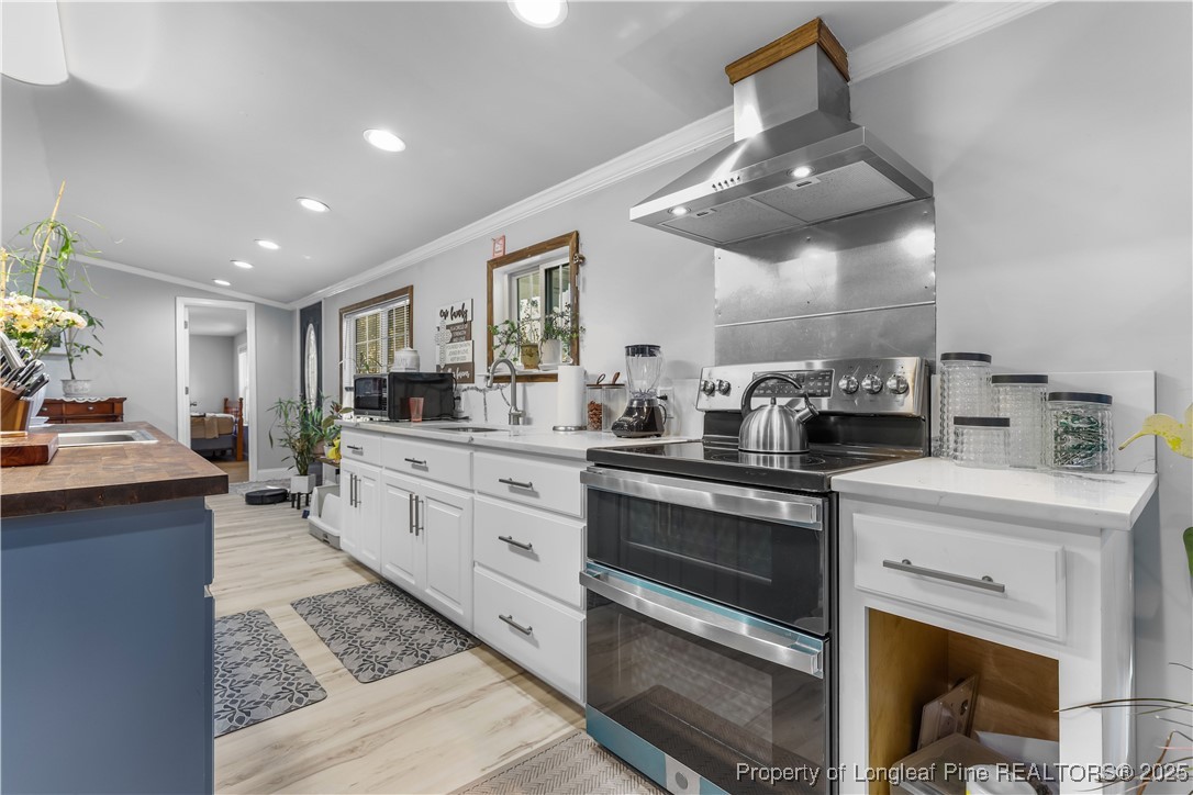 1855 Beaman Woods Road Clinton, NC 28328 - Photo 10 of 50 a kitchen with a stove cabinets and window