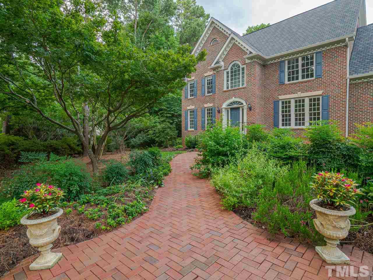 200 Claflin Court Raleigh, NC 27614 - Photo 1 of 13 a front view of a house with a yard and a garden