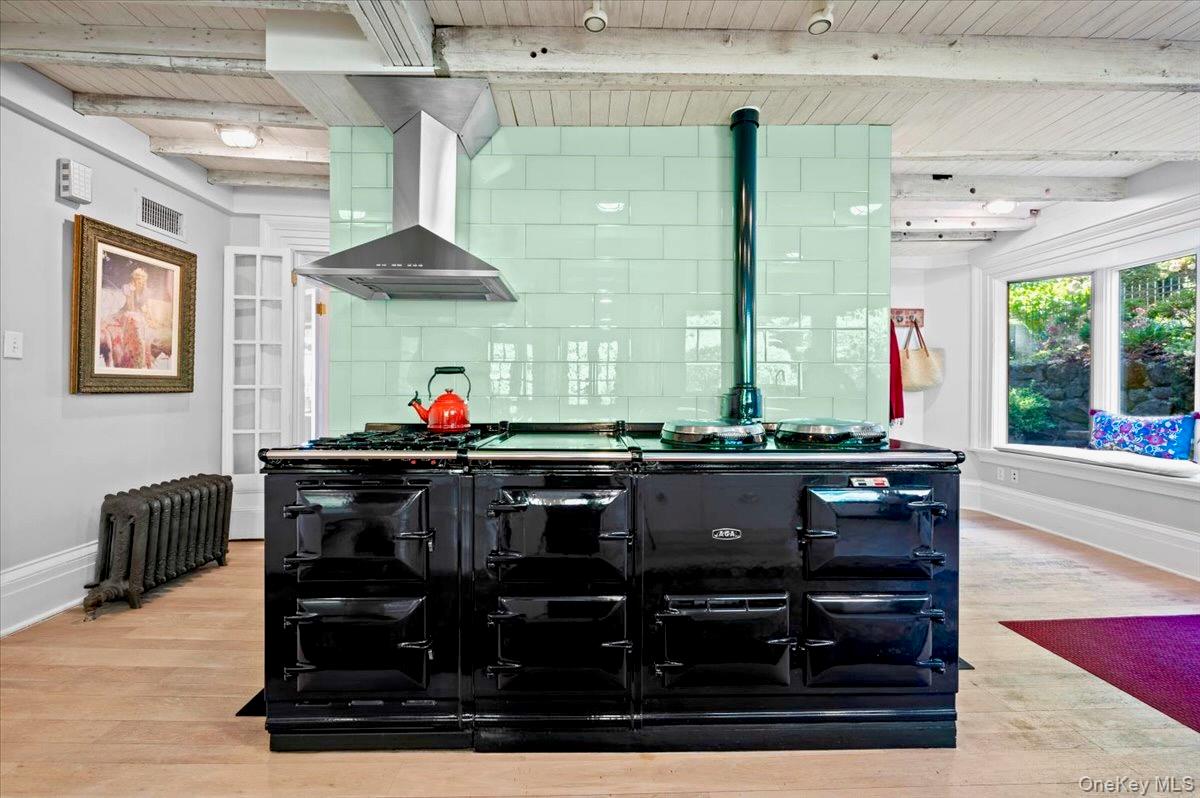 245 River Road Nyack, NY 10960 - Photo 16 of 45 Bar with exhaust hood, a wooden ceiling with exposed beams, light wood-style floors, tasteful backsplash, and radiator heating unit