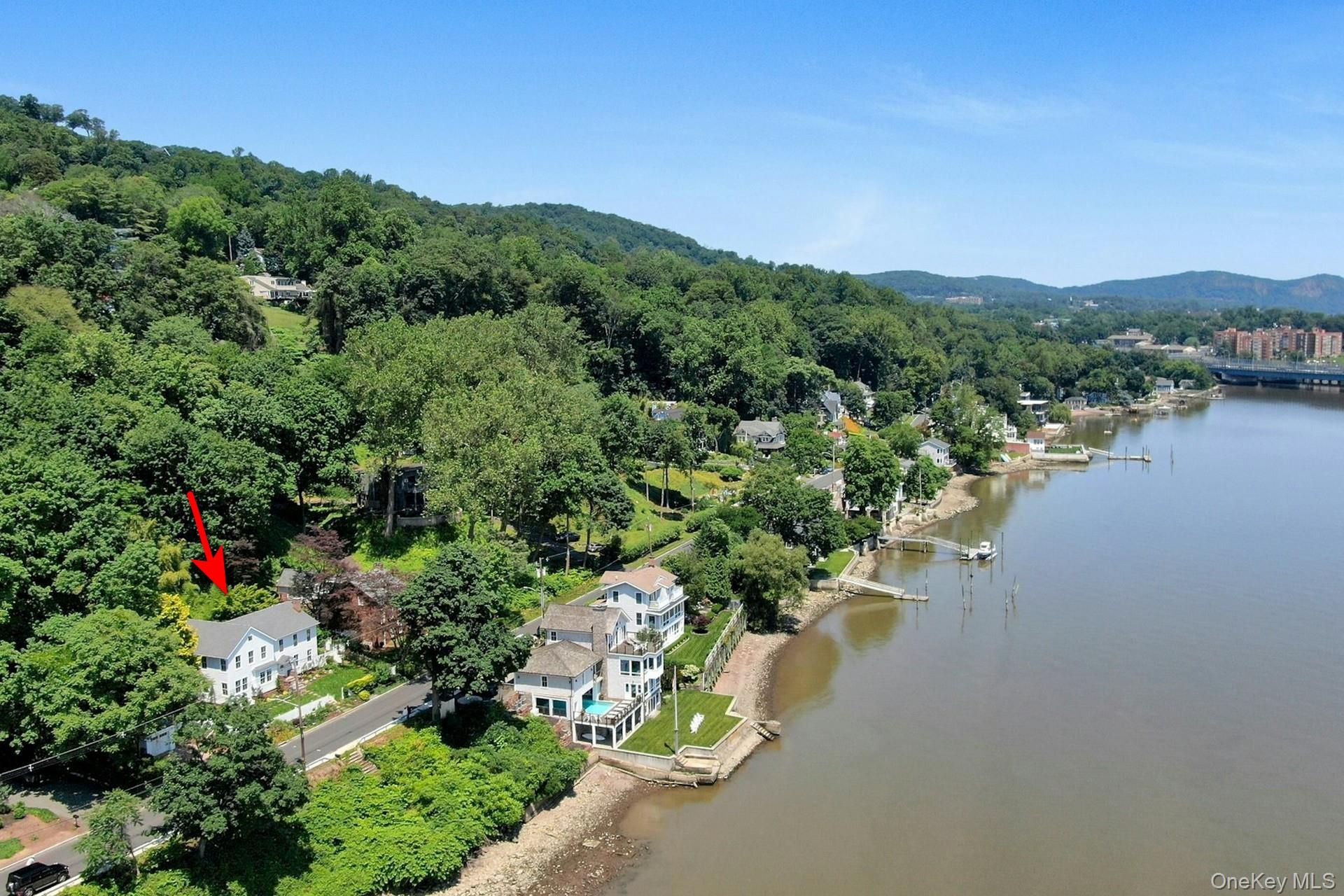 Aerial view of a water and mountain view and a heavily wooded area