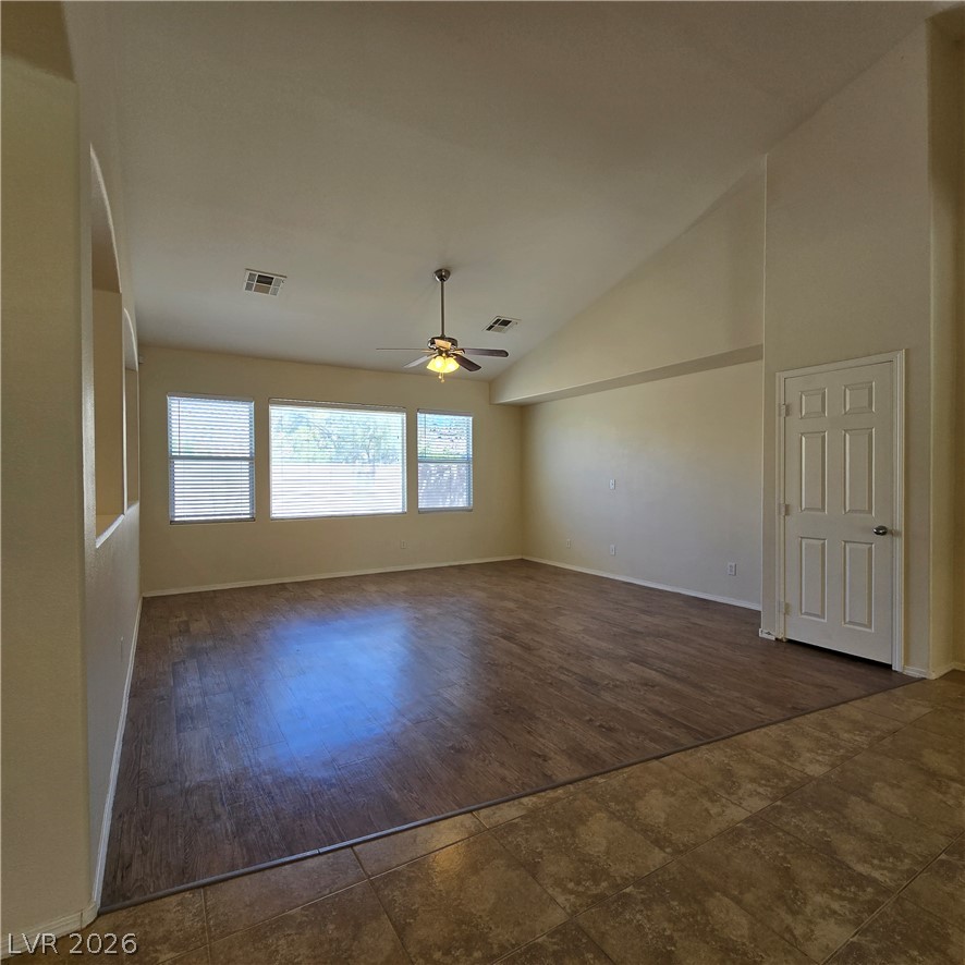 9234 Kingston Road Henderson, NV 89074 - Photo 11 of 38 A spacious living area features high ceilings and durable flooring, perfect for versatile design.