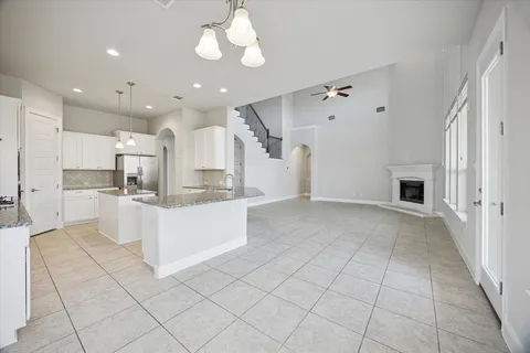 a large kitchen with a large counter top stainless steel appliances and cabinets