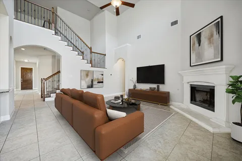 a living room with furniture a flat screen tv and a fireplace