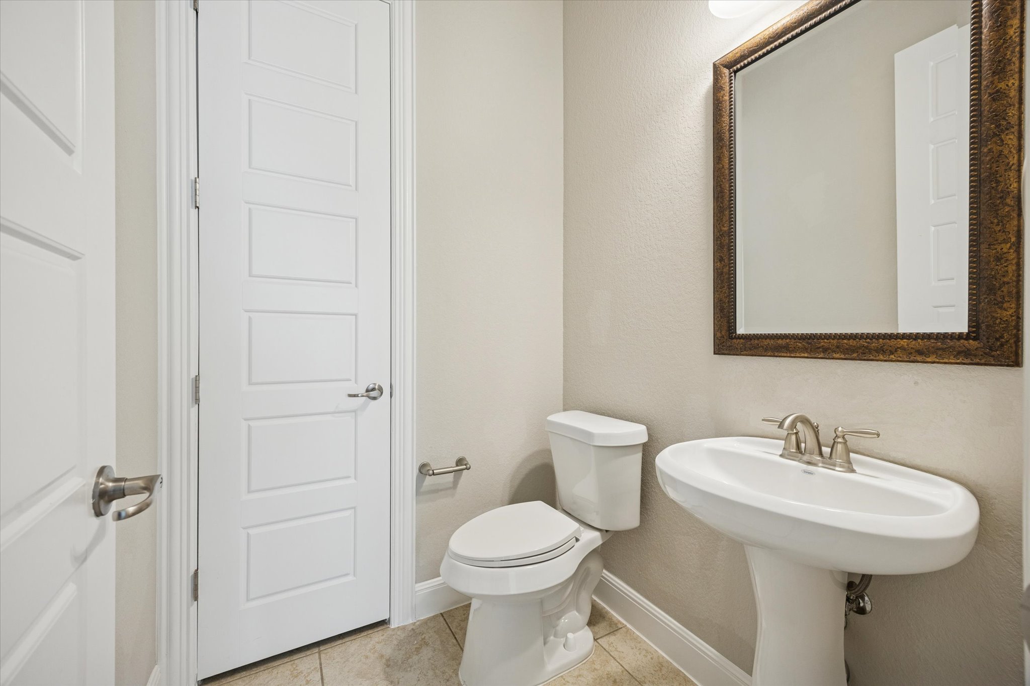 20516 Fairleaf Street Pflugerville, TX 78660 - Photo 34 of 38 a bathroom with a toilet sink and mirror
