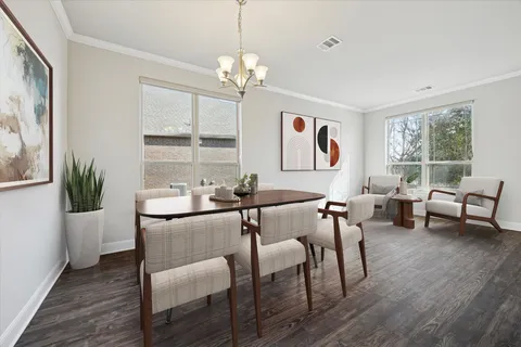 a dining room with wooden floor a chandelier a glass table and chairs