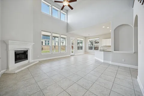 a view of an empty room with a fireplace and a window