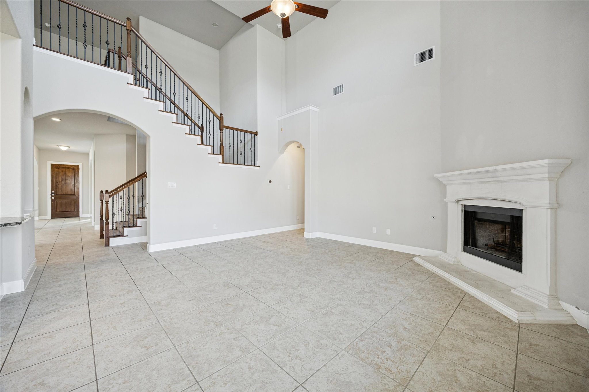 20516 Fairleaf Street Pflugerville, TX 78660 - Photo 10 of 38 Large living room with high ceilings and cozy fire place