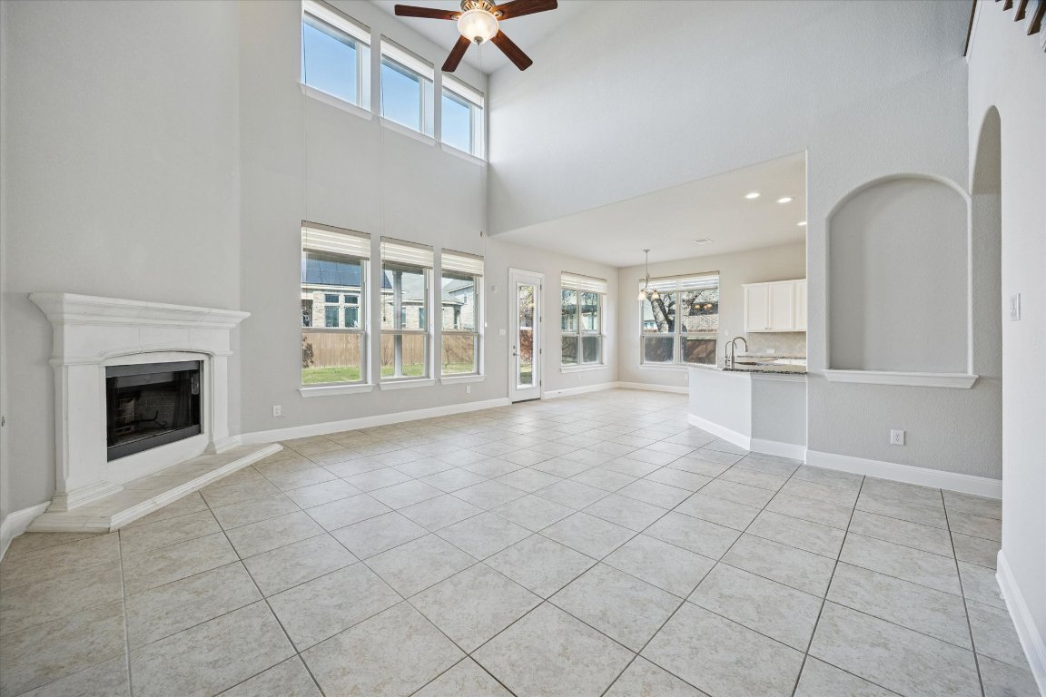 20516 Fairleaf Street Pflugerville, TX 78660 - Photo 10 of 38 Large living room with high ceilings, opens up to kitchen