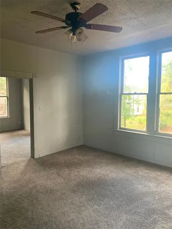 an empty room with a empty space and a ceiling fan