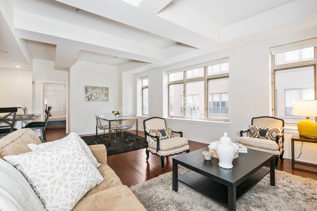 a living room with furniture and floor to ceiling windows