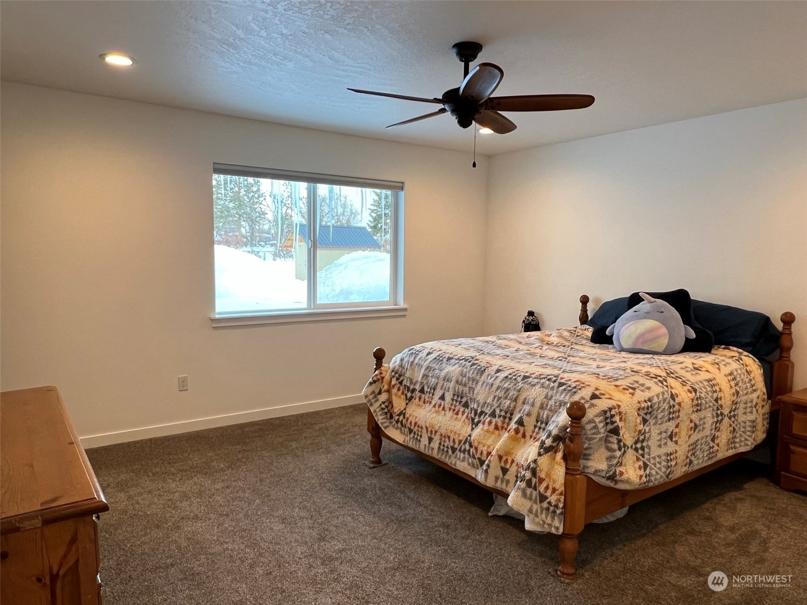 1004 Riverside Avenue Twisp, WA 98856 - Photo 13 of 40 a bedroom with a bed and a ceiling fan