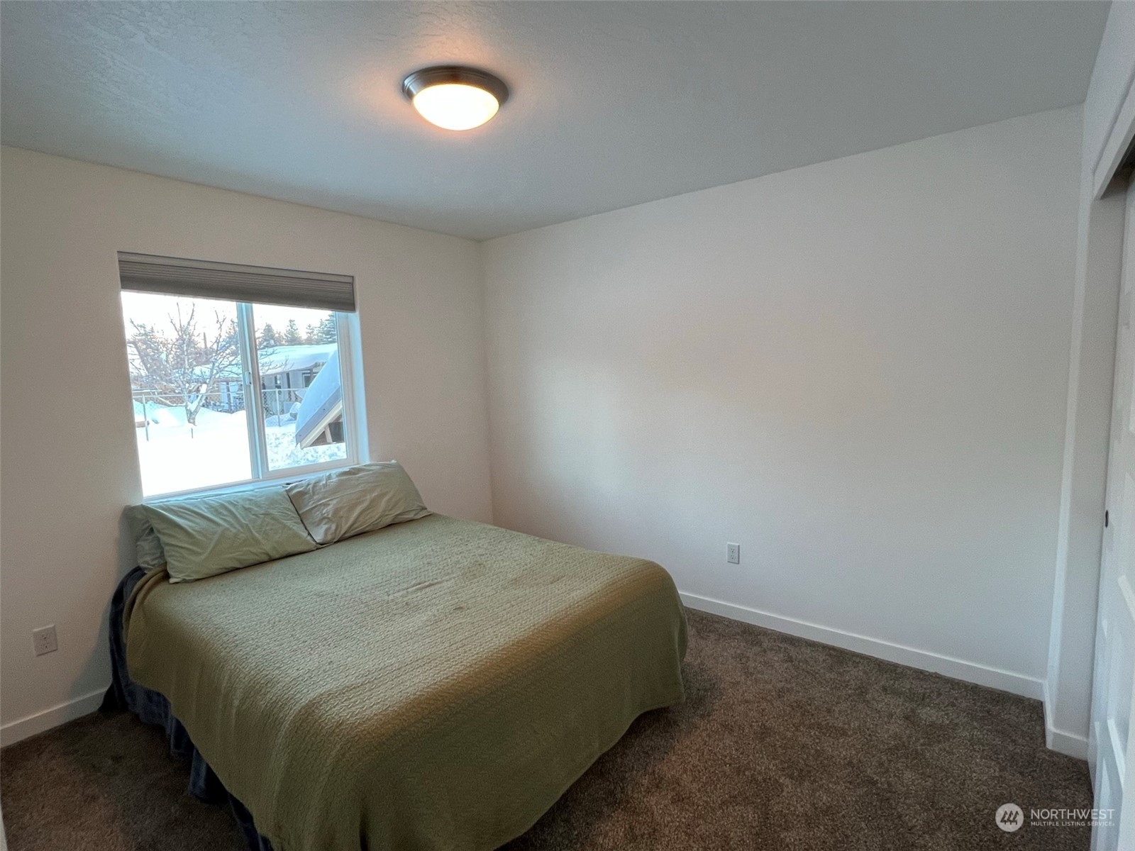 1004 Riverside Avenue Twisp, WA 98856 - Photo 15 of 40 a bedroom with a bed and window