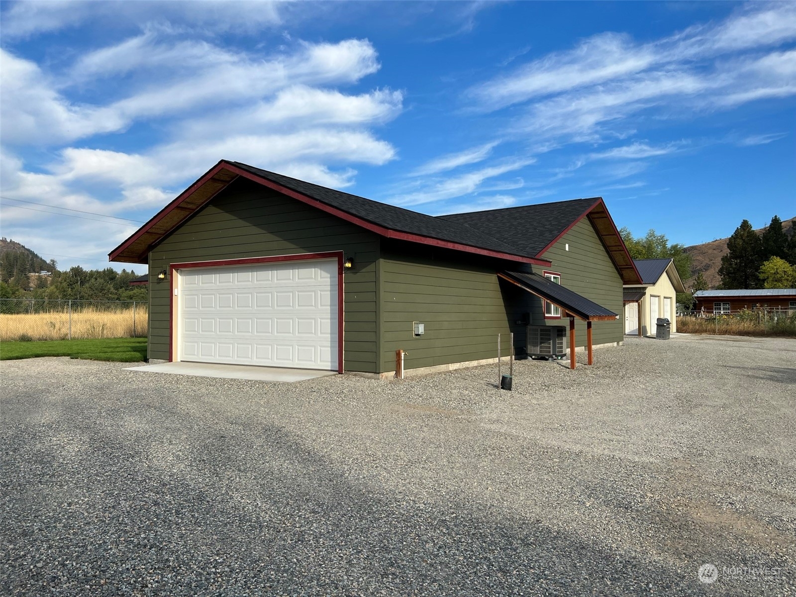 1004 Riverside Avenue Twisp, WA 98856 - Photo 19 of 40 a front view of a house with a yard and garage