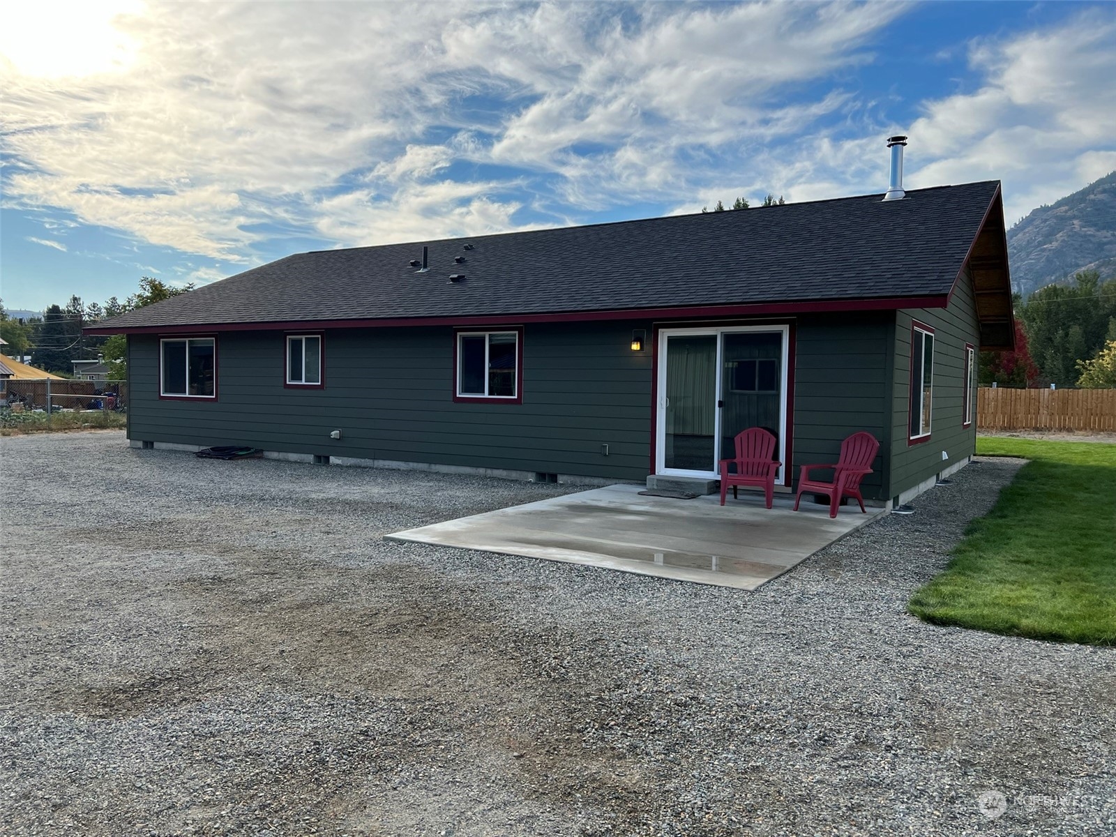 1004 Riverside Avenue Twisp, WA 98856 - Photo 22 of 40 a view of brick house with a large window and a yard
