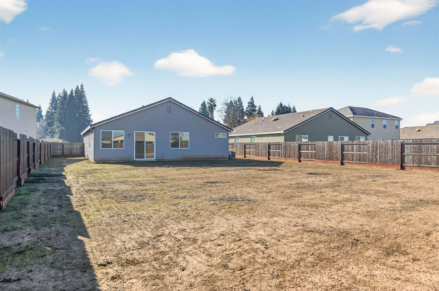 2431 Creekview Drive Merced, CA 95340 - Photo 24 of 38 a front view of a house with a yard and garage