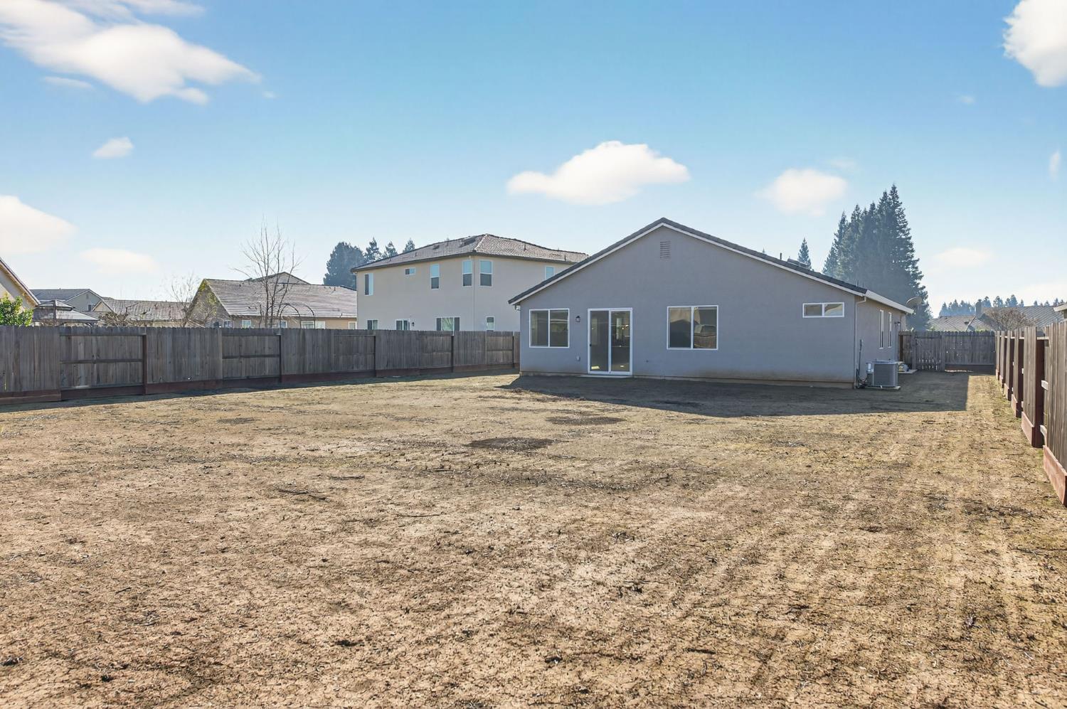 2431 Creekview Drive Merced, CA 95340 - Photo 25 of 38 a front view of a house with a yard and a garage