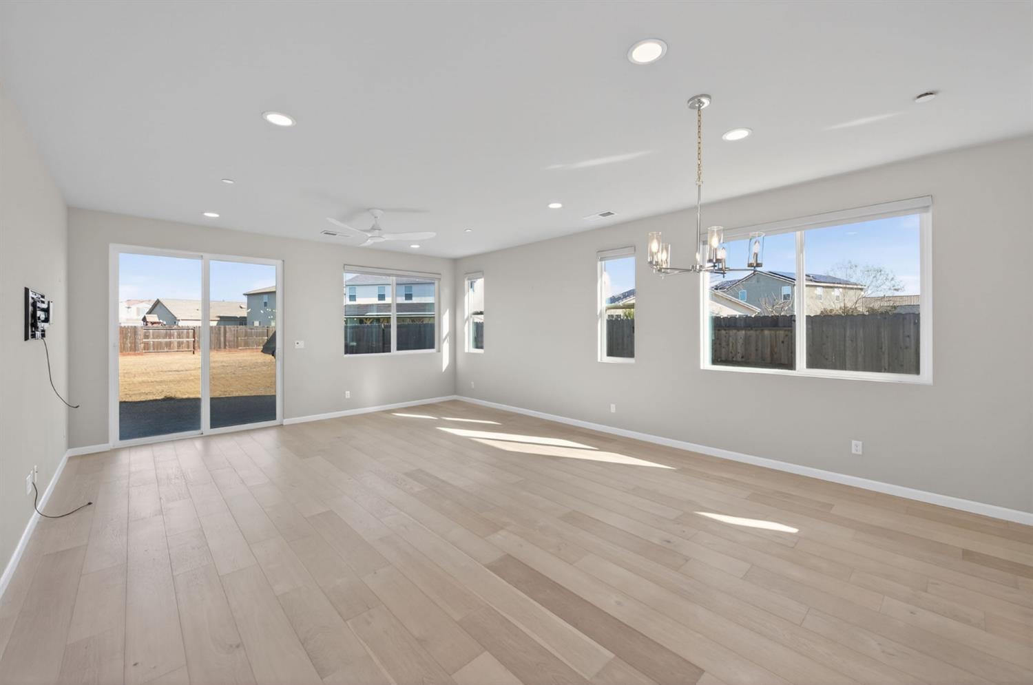 2431 Creekview Drive Merced, CA 95340 - Photo 3 of 38 an empty room with wooden floor and windows