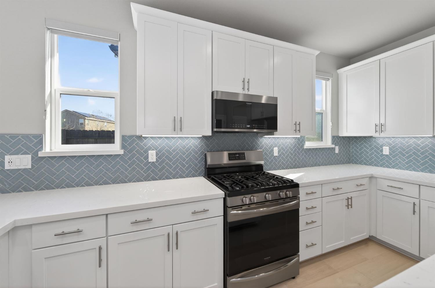 2431 Creekview Drive Merced, CA 95340 - Photo 8 of 38 a kitchen with white cabinets stainless steel appliances and sink