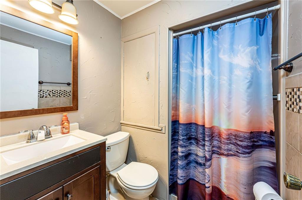 621 Sandy Hill Road Irwin, PA 15642 - Photo 22 of 50 a bathroom with a granite countertop toilet sink and mirror