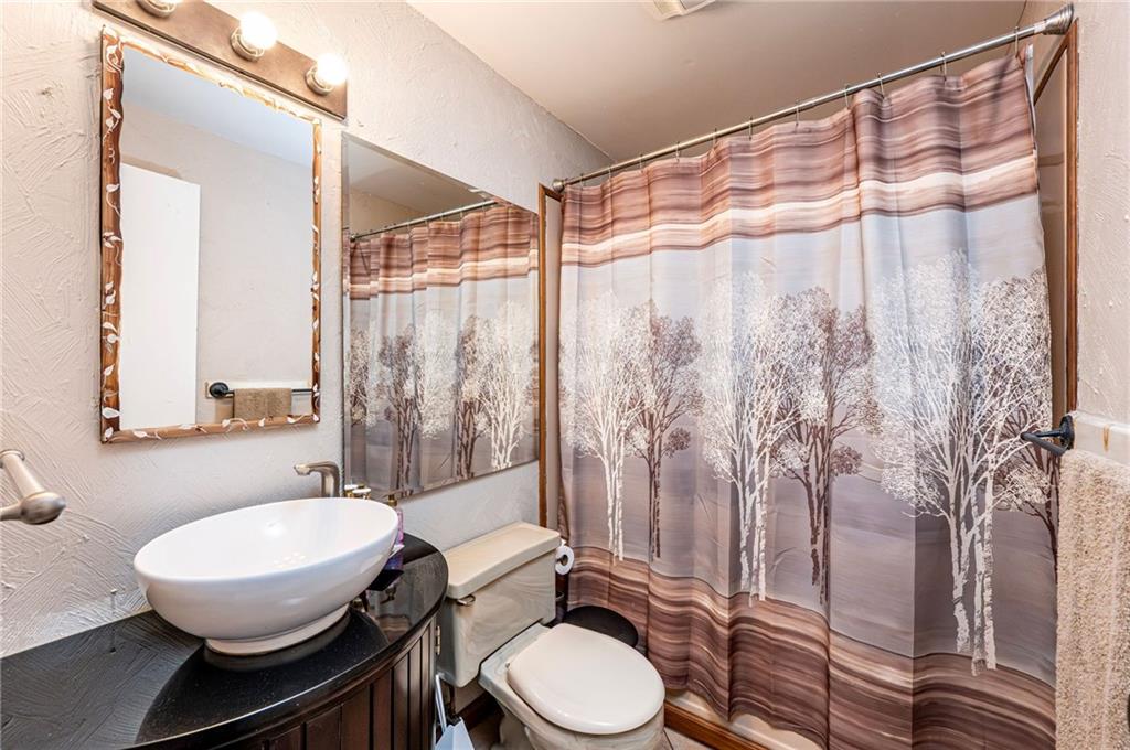 621 Sandy Hill Road Irwin, PA 15642 - Photo 25 of 50 a bathroom with a granite countertop bathtub sink vanity mirror and toilet