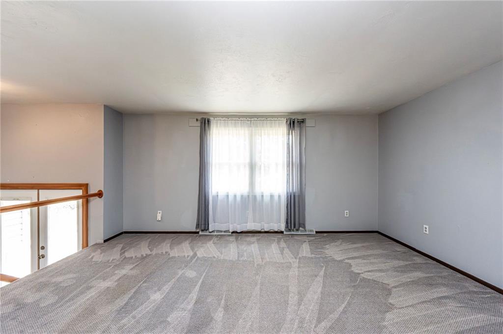 621 Sandy Hill Road Irwin, PA 15642 - Photo 7 of 50 an empty room with wooden floor and windows
