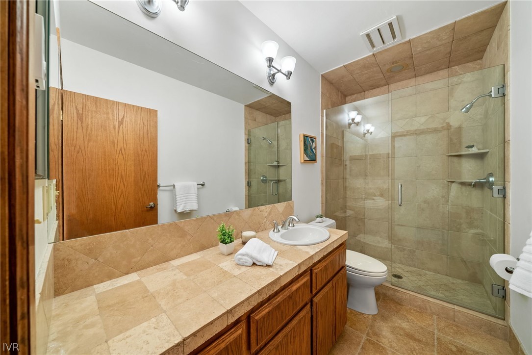 106 Jobs Peak Road Incline Village, NV 89451 - Photo 15 of 49 a bathroom with a granite countertop sink a toilet a mirror and shower