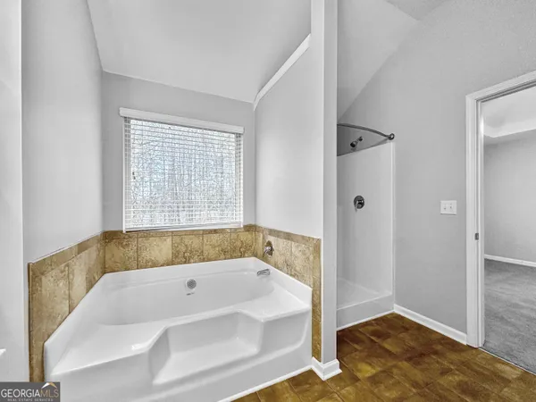 a bathroom with a bathtub and shower