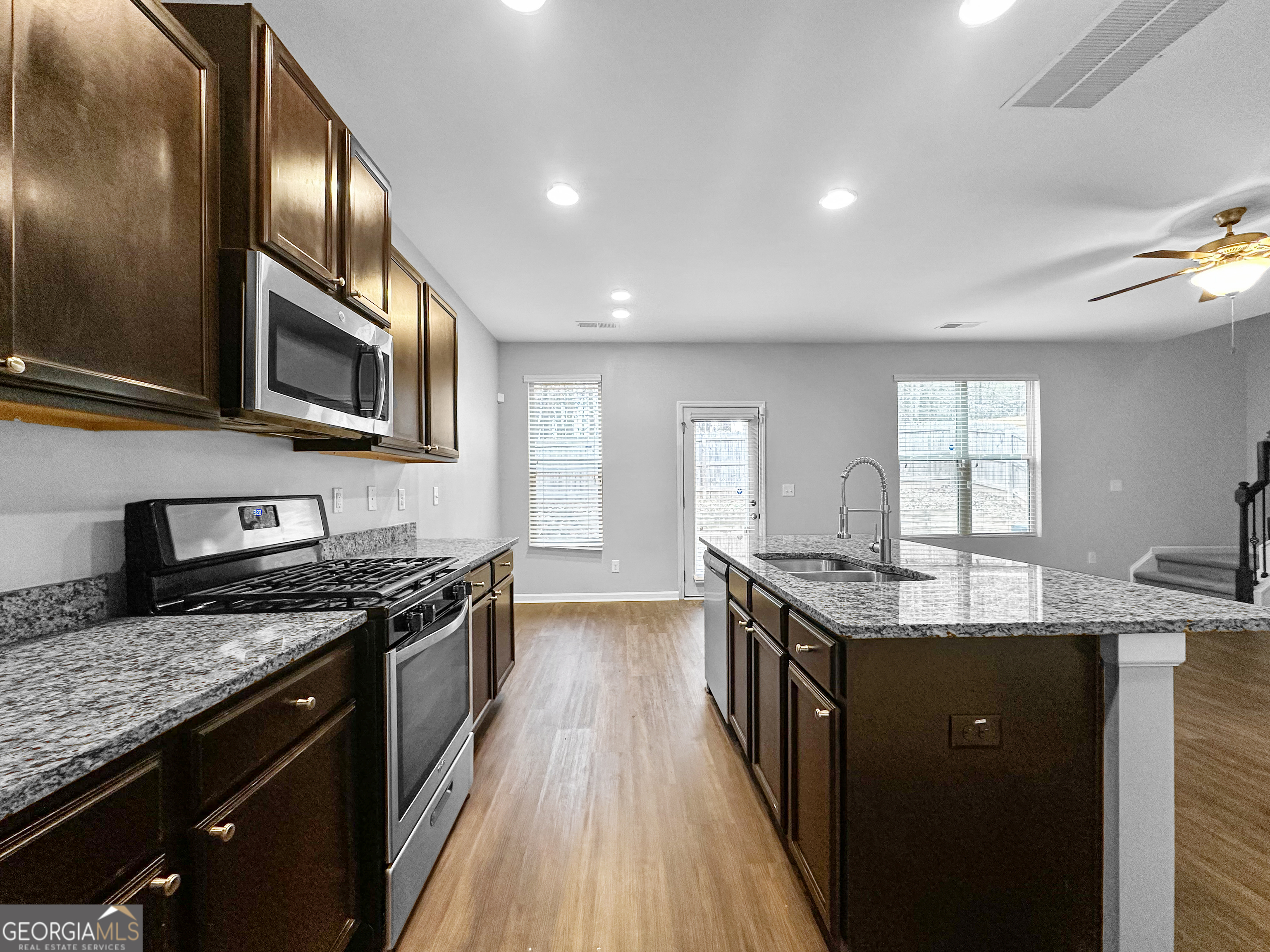 5689 Grande River Road Atlanta, GA 30349 - Photo 8 of 18 a kitchen with granite countertop stainless steel appliances and wooden cabinets