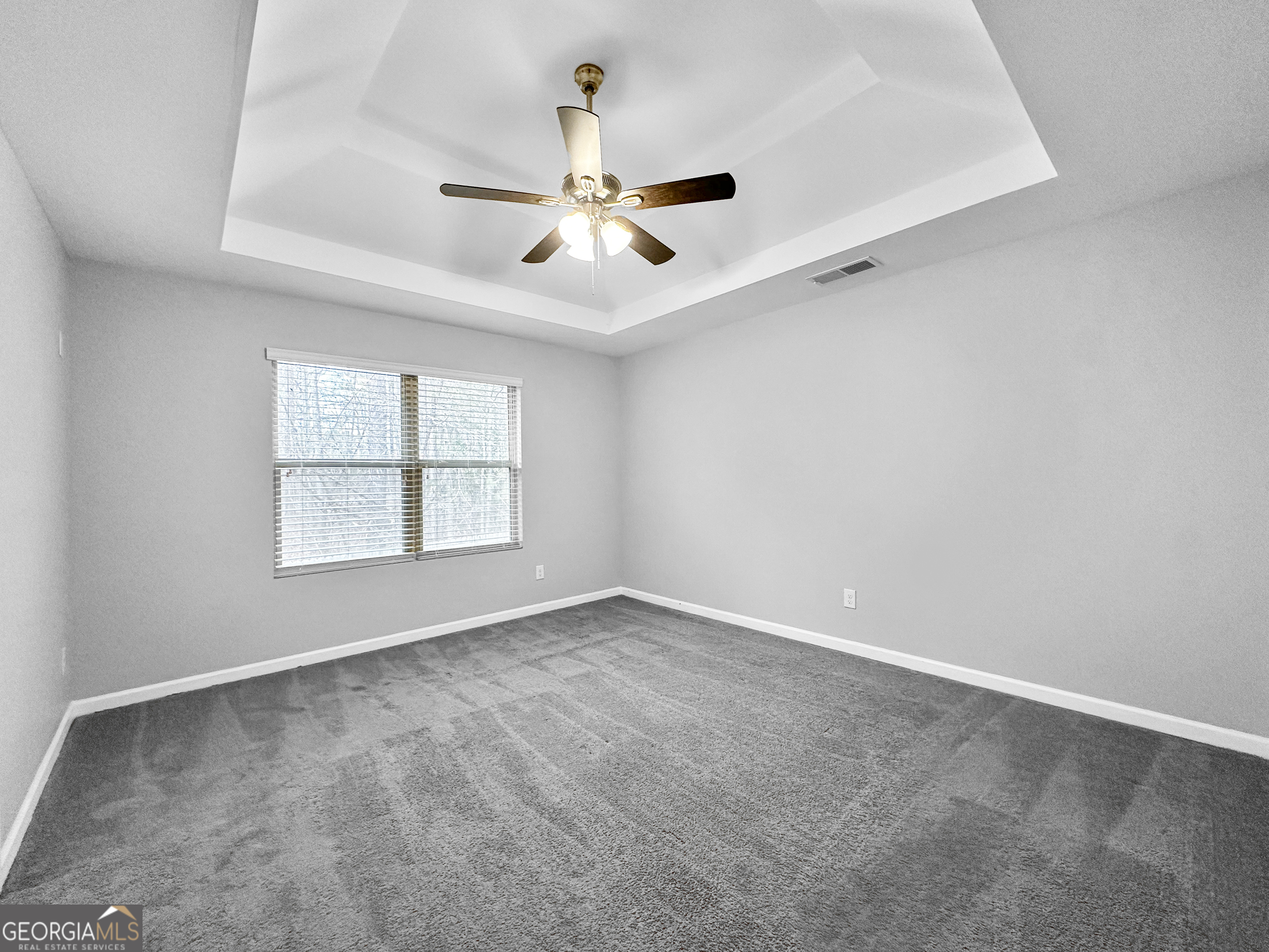 5689 Grande River Road Atlanta, GA 30349 - Photo 10 of 18 an empty room with windows and fan