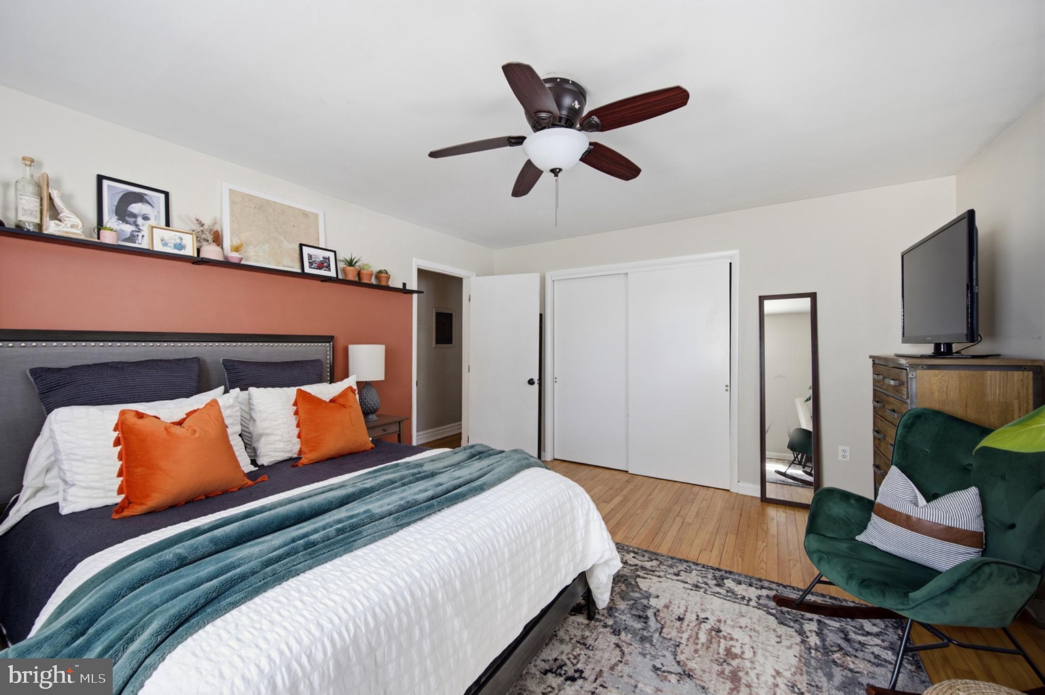 6750 Glenkirk Road Baltimore, MD 21239 - Photo 12 of 60 a bedroom with a bed and wooden floor