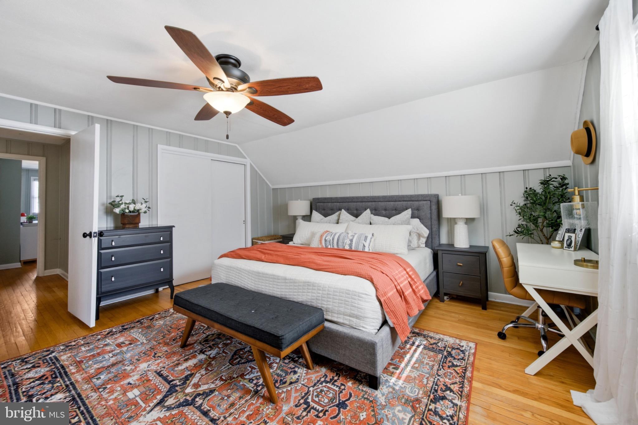 6750 Glenkirk Road Baltimore, MD 21239 - Photo 20 of 60 a bedroom with a bed and wooden floor