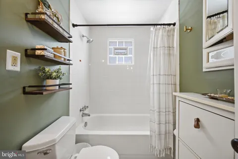 a living room with furniture and a book shelf