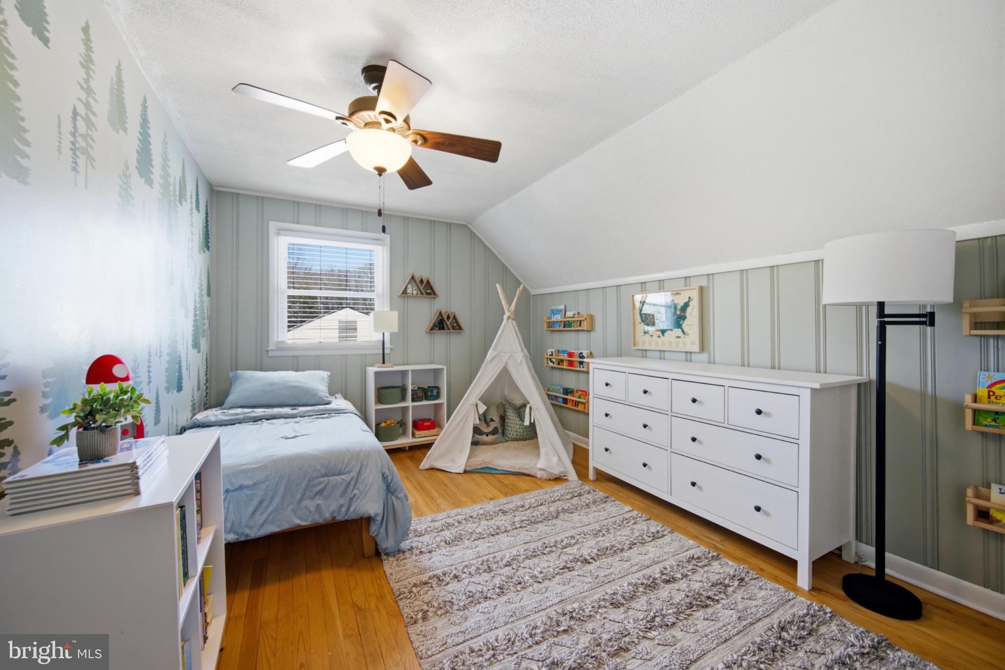 6750 Glenkirk Road Baltimore, MD 21239 - Photo 25 of 60 a bedroom with a bed and wooden floor